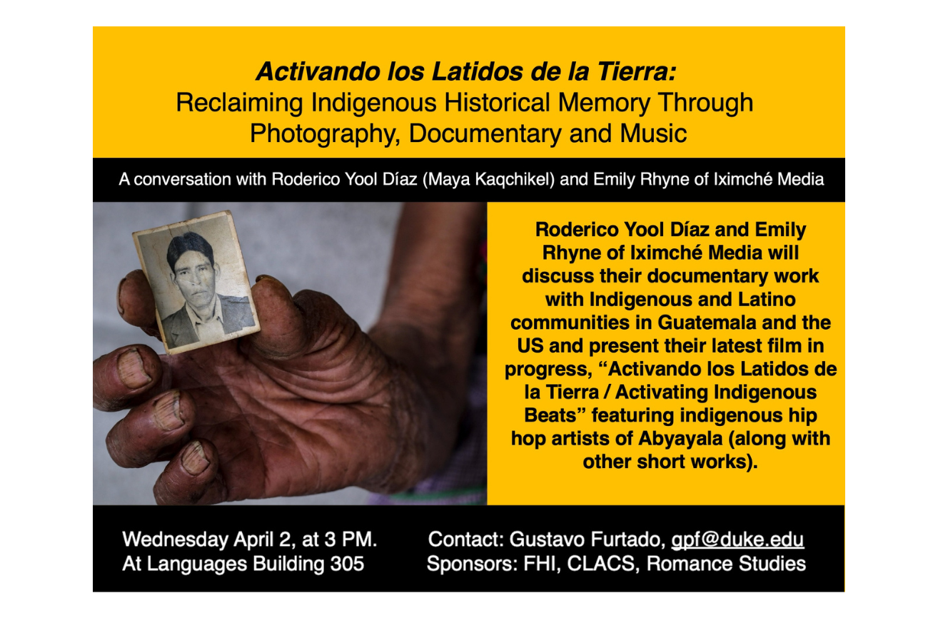 person holding an old photograph of a man on a flyer announcing the event